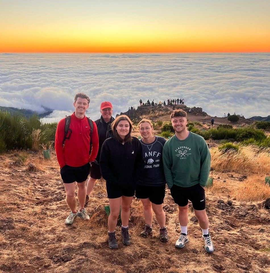 Andy and his family watching the sunrise above the clouds in Madeira